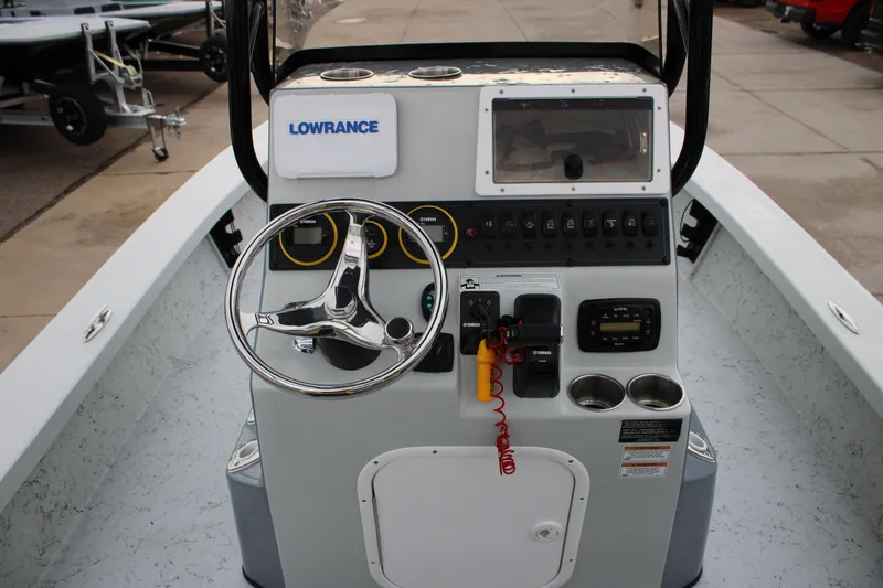 Slide: The Image of 2011 Blue Wave 2200 STL boat console with steering wheel and controls. - 20