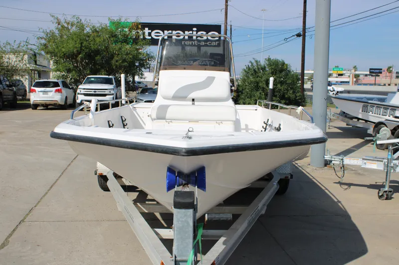 Slide: The Image of 2011 Blue Wave 2200 STL boat on trailer in parking lot. - 21