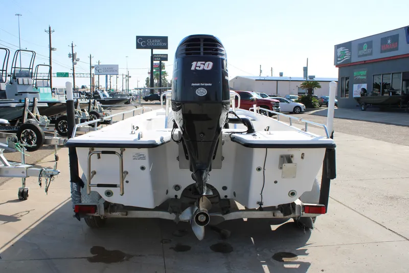 Slide: The Image of 2011 Blue Wave 2200 STL boat with 150 HP engine, parked at dealership. - 3