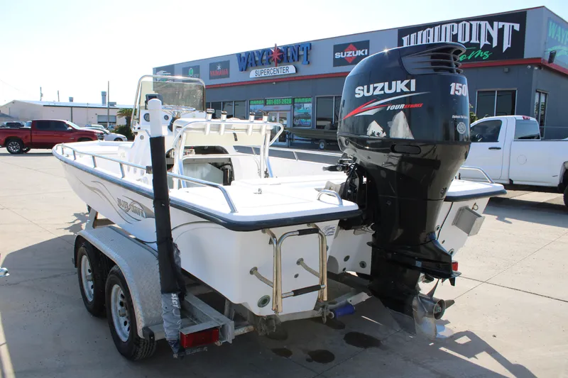Slide: The Image of 2011 Blue Wave 2200 STL boat with Suzuki 150 outboard motor on trailer. - 4