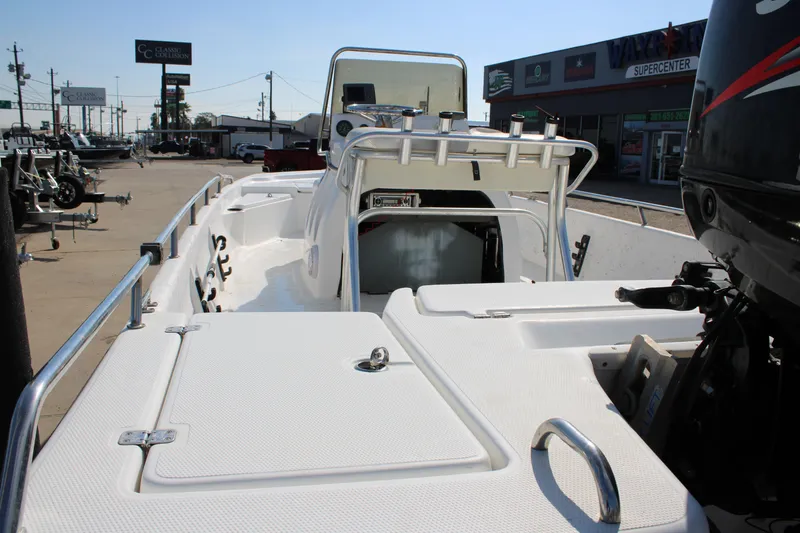 Slide: The Image of 2011 Blue Wave 2200 STL boat at dealership, showcasing deck and seating area. - 5