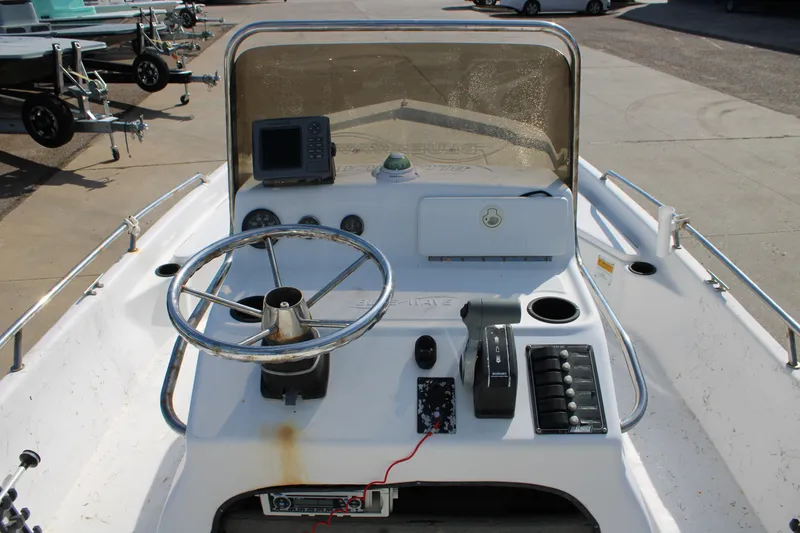 Slide: The Image of 2011 Blue Wave 2200 STL boat console with steering wheel and navigation equipment. - 8