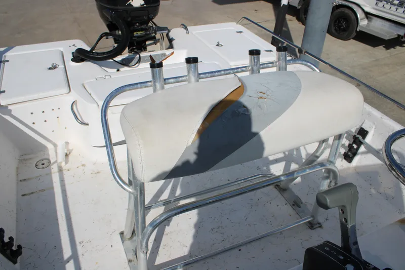 Slide: The Image of 2011 Blue Wave 2200 STL boat with damaged white seat and metal frame. - 9