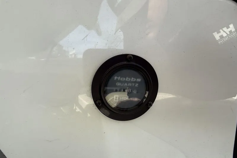 Slide: The Image of Hour meter on a 2004 Cobalt 250 boat, displaying usage hours. - 11