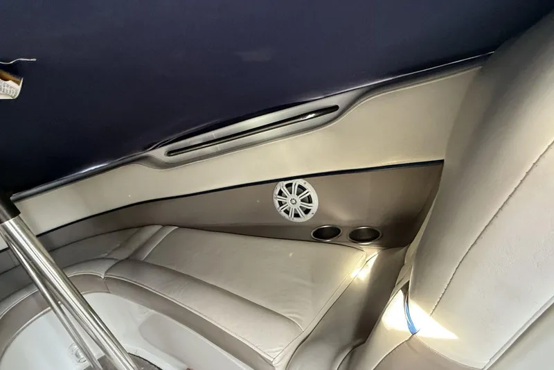 Slide: The Image of 2004 Cobalt 250 boat interior with speaker and cup holders. - 14