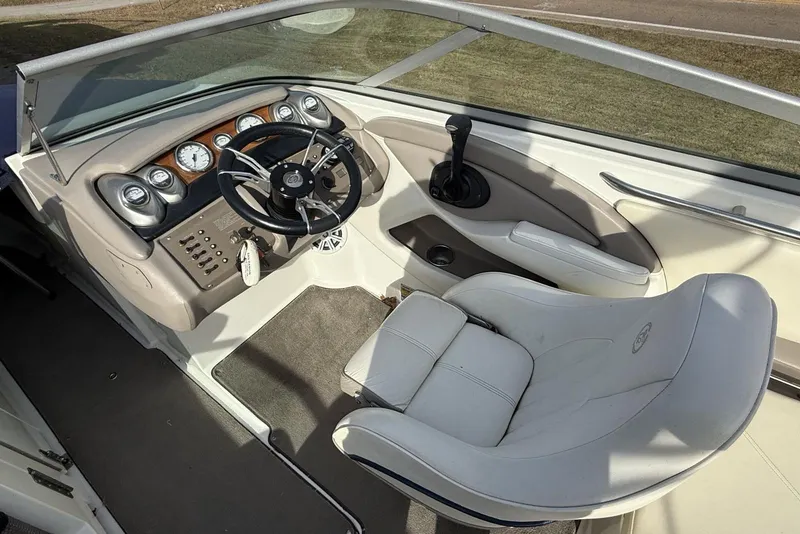 Slide: The Image of 2004 Cobalt 250 boat interior with steering wheel and dashboard controls. - 15