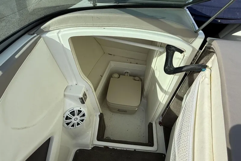 Slide: The Image of 2004 Cobalt 250 boat interior with compact toilet and speaker. - 17