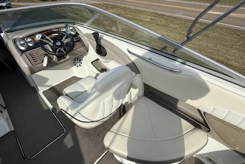 Slide: The Image of 2004 Cobalt 250 boat interior with steering wheel and seating, showcasing elegant design. - 19