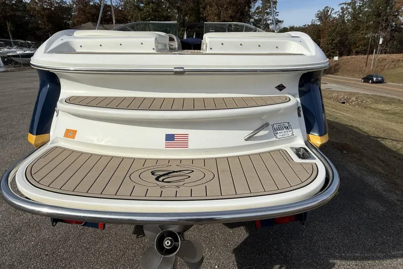 Slide: The Image of Rear view of a 2004 Cobalt 250 boat with swim platform and American flag. - 23