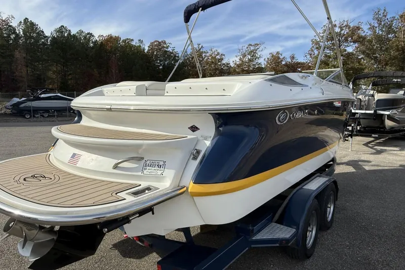 Slide: The Image of 2004 Cobalt 250 boat on trailer, featuring sleek design and spacious deck. - 7