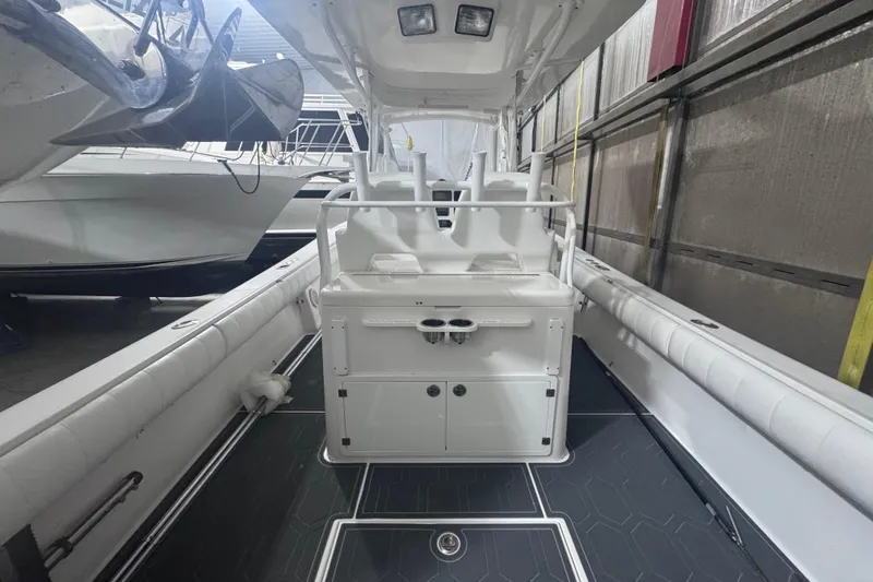 Slide: The Image of 2010 Regulator 34SS boat interior with seating and storage, docked indoors. - 16