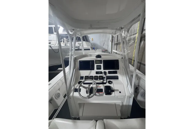 Slide: The Image of 2010 Regulator 34SS boat cockpit with steering wheel and navigation controls. - 19