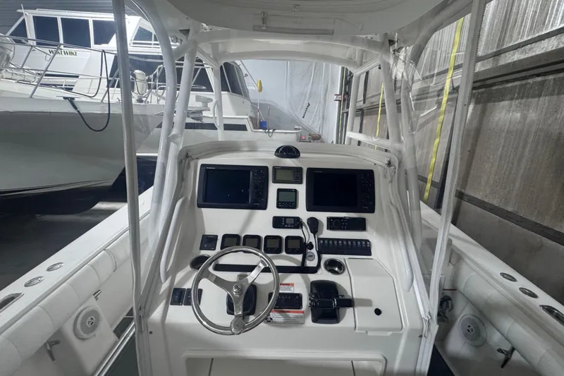 Slide: The Image of 2010 Regulator 34SS boat cockpit with advanced navigation controls and steering wheel. - 20
