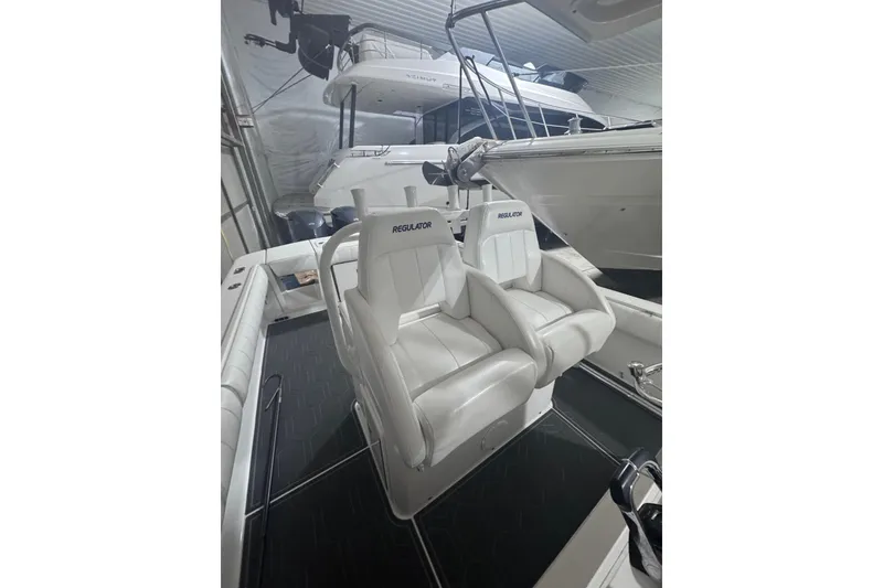 Slide: The Image of 2010 Regulator 34SS boat interior with white seating in a showroom. - 22