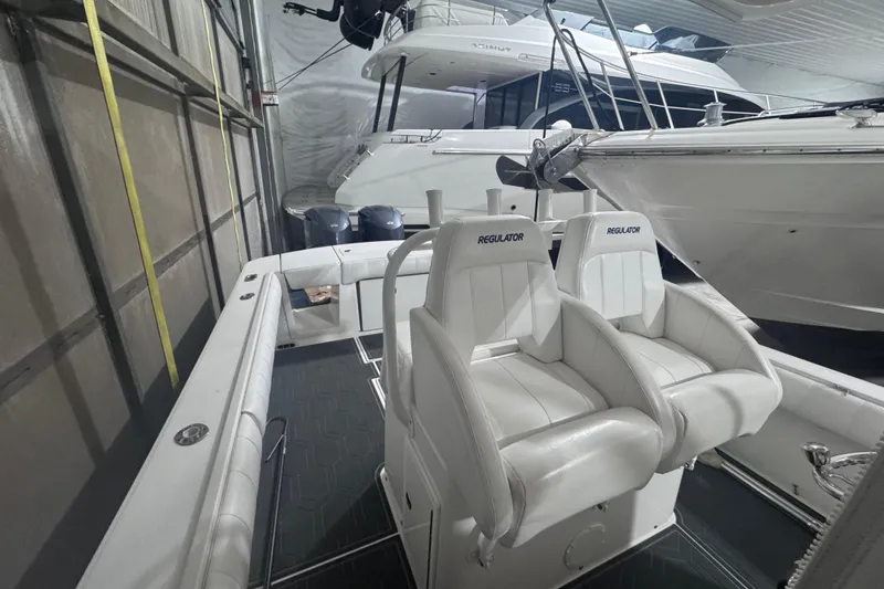 Slide: The Image of 2010 Regulator 34SS boat interior with white seating in storage. - 23