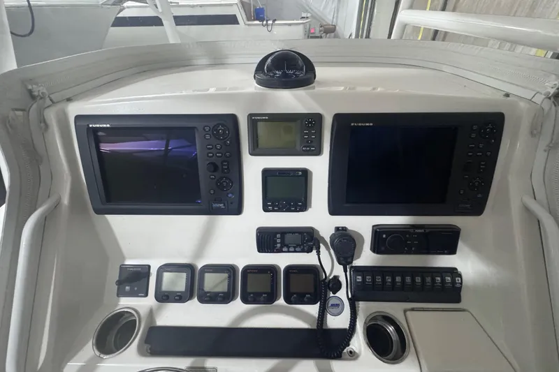 Slide: The Image of Control panel of a 2010 Regulator 34SS boat with navigation and communication equipment. - 24