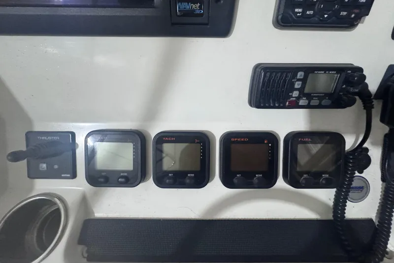 Slide: The Image of Control panel of a 2010 Regulator 34SS boat with various gauges and radio. - 25