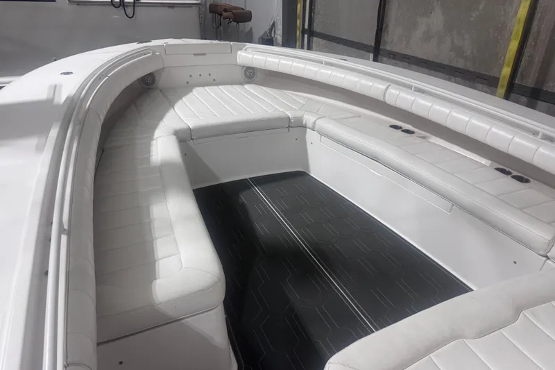 Slide: The Image of 2010 Regulator 34SS boat interior with white cushioned seating and sleek design. - 31