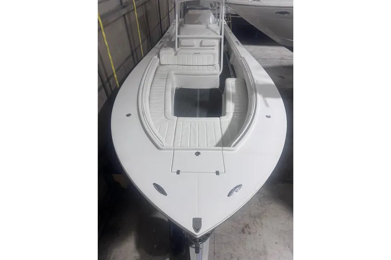 Slide: The Image of 2010 Regulator 34SS boat with spacious seating and sleek design in a storage facility. - 35