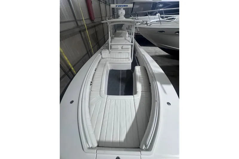 Slide: The Image of 2010 Regulator 34SS boat with white seating, docked indoors. - 36