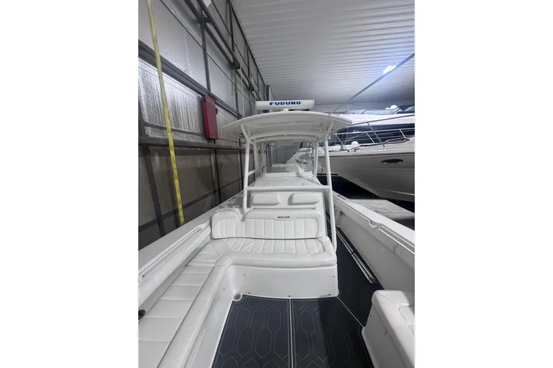 Slide: The Image of 2010 Regulator 34SS boat in storage, featuring white seating and a Furuno radar. - 37