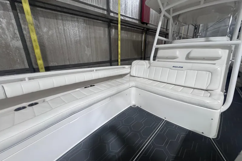 Slide: The Image of 2010 Regulator 34SS boat interior with white cushioned seating and sleek design. - 39