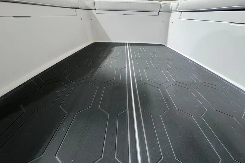 Slide: The Image of 2010 Regulator 34SS boat interior with textured flooring and cushioned seating. - 42