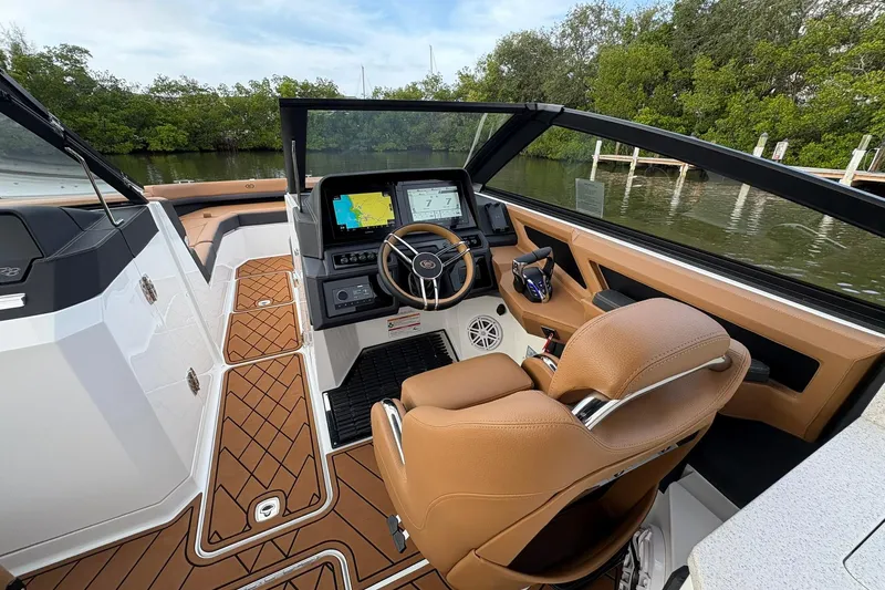Slide: The Image of Interior of 2026 Cobalt R8 Outboard boat with modern dashboard and tan seating. - 10
