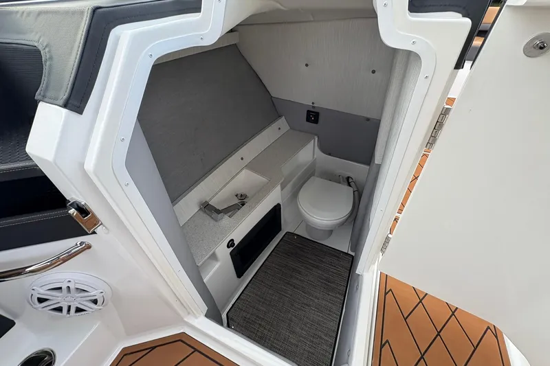 Slide: The Image of 2026 Cobalt R8 Outboard boat interior with compact bathroom and modern amenities. - 12