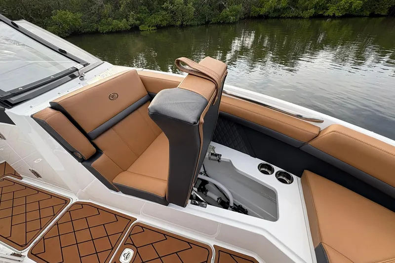 Slide: The Image of 2026 Cobalt R8 Outboard boat interior with tan leather seating and cup holders. - 13