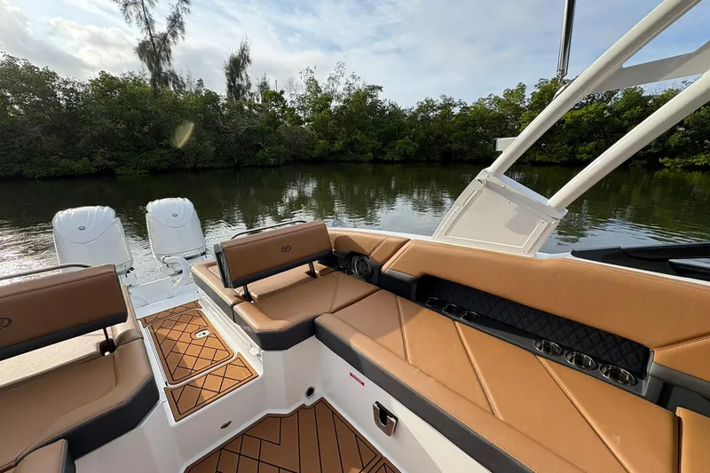 Slide: The Image of 2026 Cobalt R8 Outboard boat interior with tan seating, on a calm river. - 17
