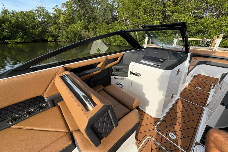 Slide: The Image of Luxurious interior of 2026 Cobalt R8 Outboard boat with tan leather seating and modern dashboard. - 18