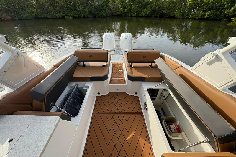 Slide: The Image of 2026 Cobalt R8 Outboard boat interior with tan seating and storage compartments. - 21