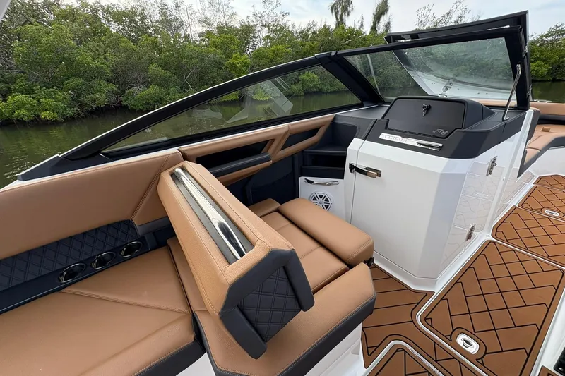 Slide: The Image of 2026 Cobalt R8 Outboard boat interior with tan seating and modern dashboard design. - 9