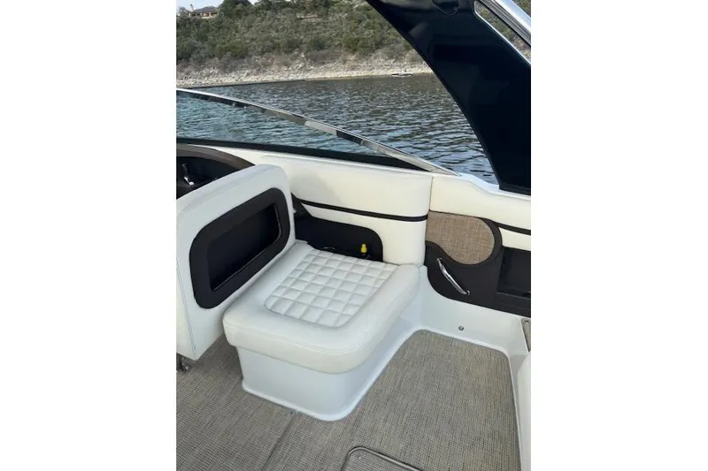 Slide: The Image of 2017 Cobalt R30 boat interior with white cushioned seating and lake view. - 2