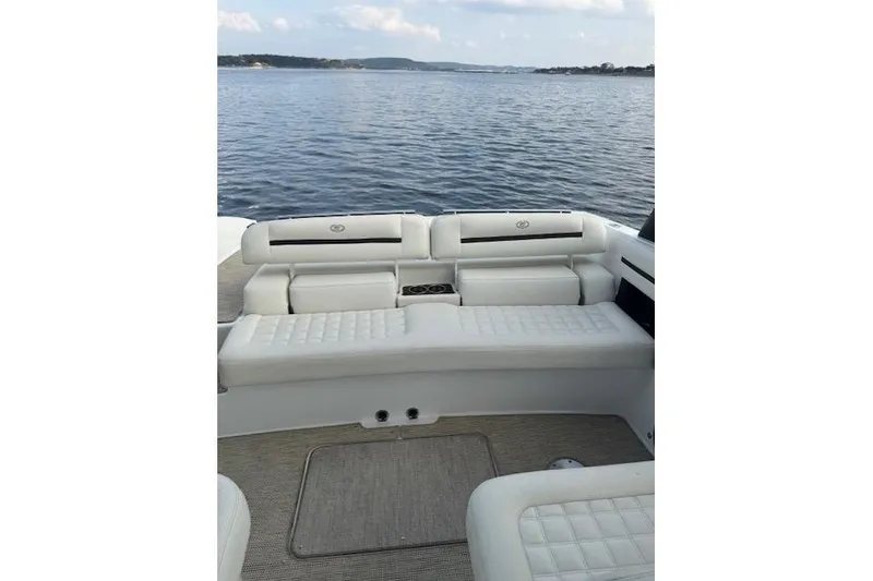 Slide: The Image of 2017 Cobalt R30 boat interior with white seating, overlooking calm water. - 3