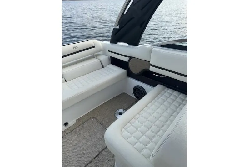 Slide: The Image of 2017 Cobalt R30 boat interior with white quilted seating and lake view. - 4