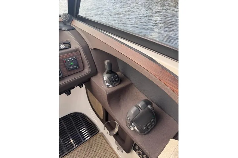 Slide: The Image of 2017 Cobalt R30 boat controls with joystick and throttle near water. - 6