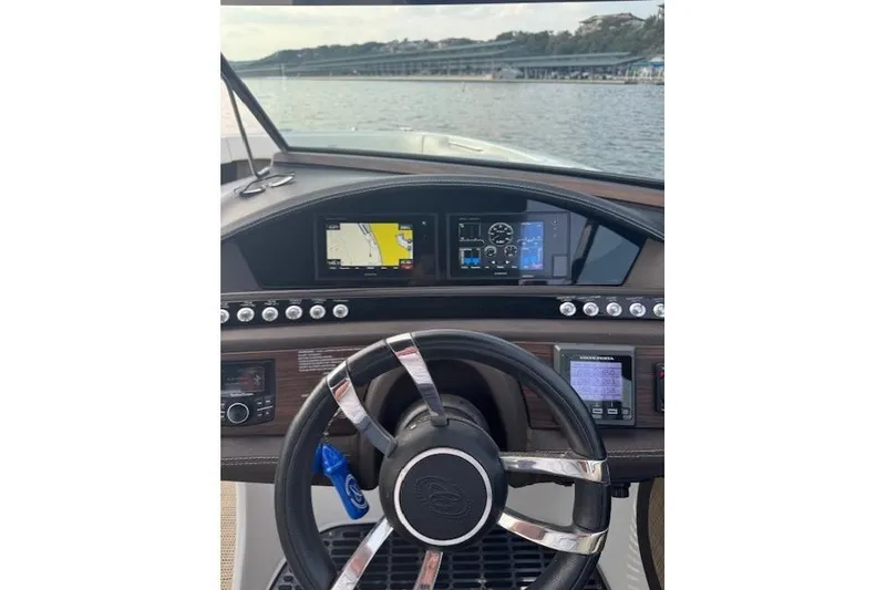 Slide: The Image of Steering wheel and dashboard of a 2017 Cobalt R30 boat on the water. - 7