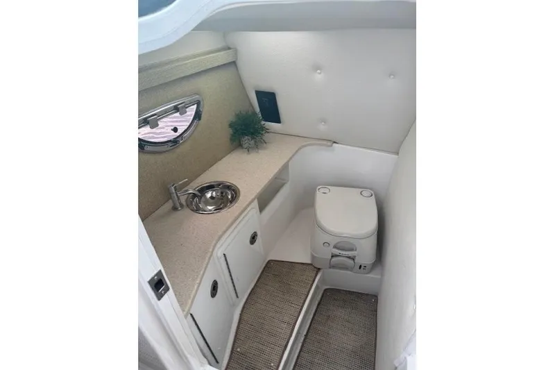Slide: The Image of 2017 Cobalt R30 boat interior with compact bathroom, sink, and toilet. - 8