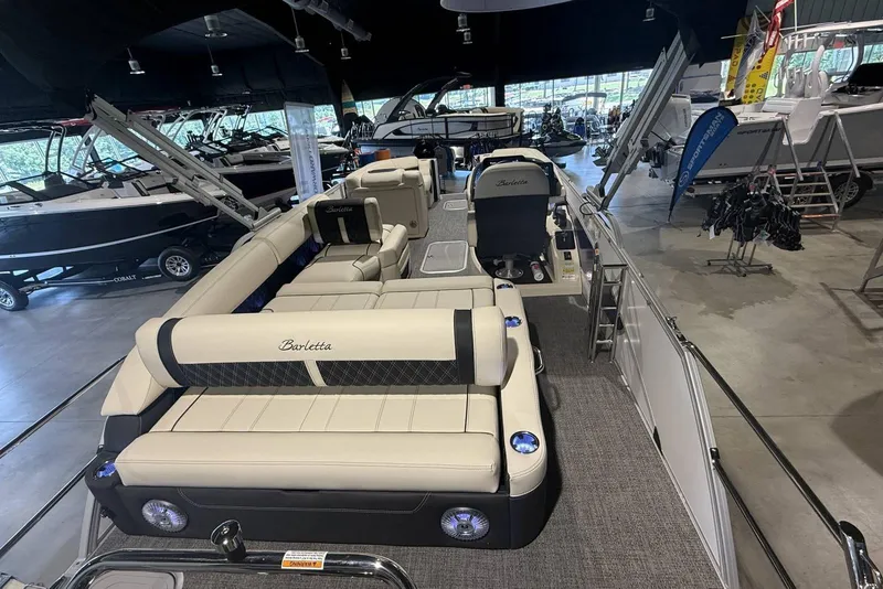 Slide: The Image of 2026 Barletta Lusso 23U pontoon boat interior with luxurious seating in showroom. - 14