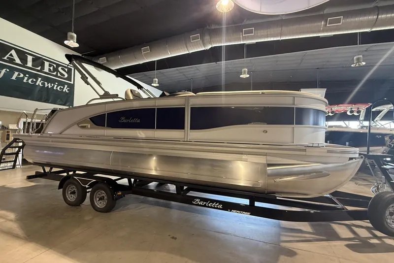 Slide: The Image of 2026 Barletta Lusso 23U pontoon boat displayed indoors on a trailer. - 3