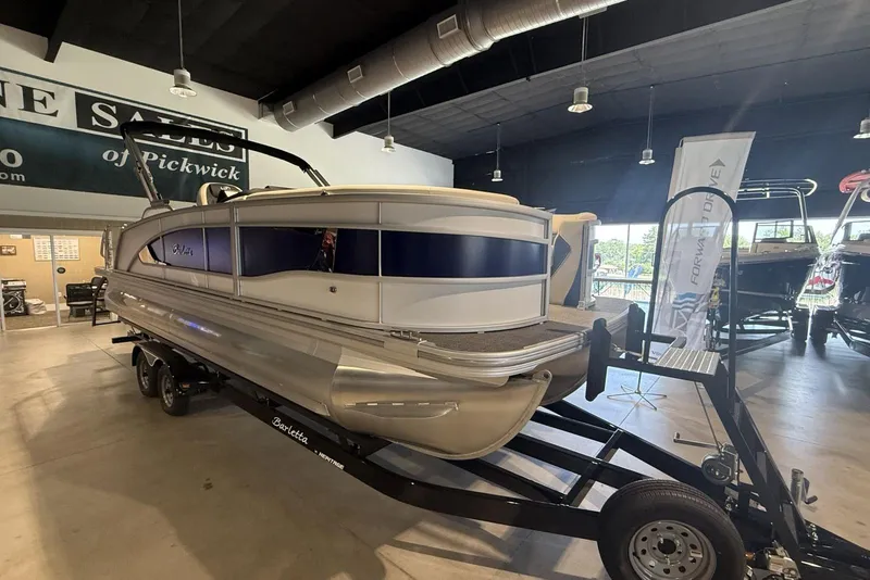 Slide: The Image of 2026 Barletta Lusso 23U pontoon boat displayed indoors on a trailer. - 4