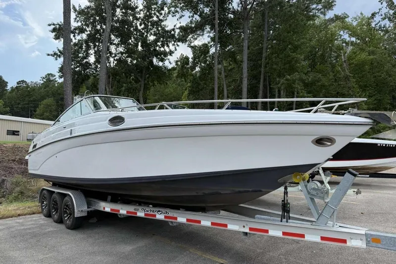 Slide: The Image of 2005 Crownline 288 BR boat on trailer, parked outdoors near trees. - 1