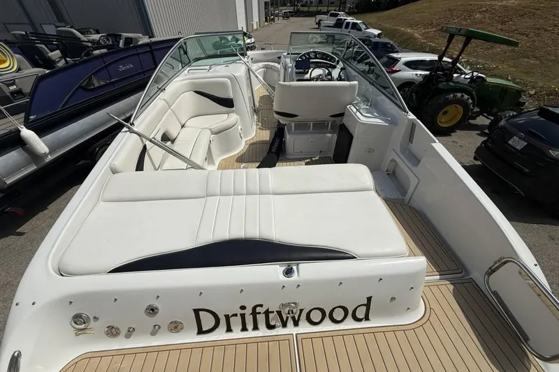 Slide: The Image of 2005 Crownline 288 BR boat named "Driftwood" with spacious seating and sleek design. - 10