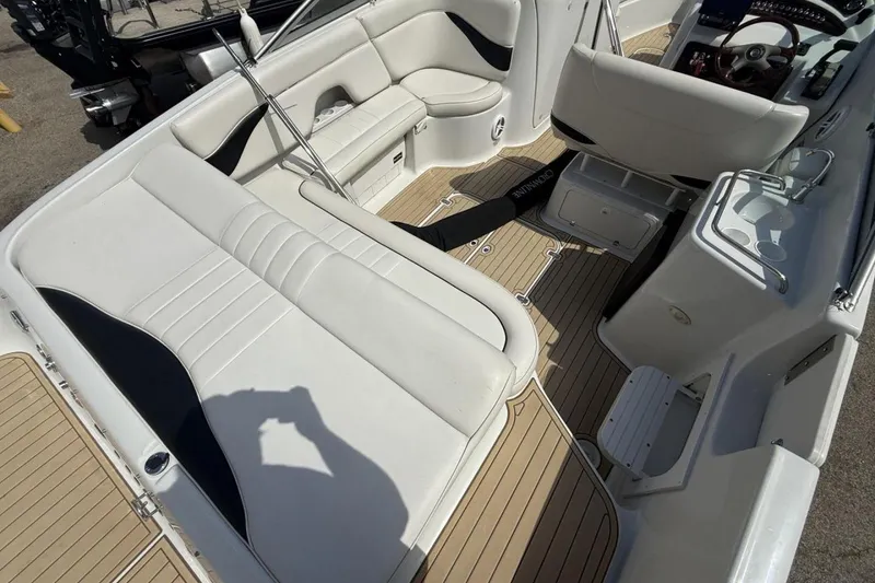 Slide: The Image of 2005 Crownline 288 BR boat interior with white seating and wood-style flooring. - 11