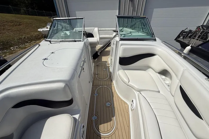 Slide: The Image of 2005 Crownline 288 BR boat interior with white seating and wood-style flooring. - 20