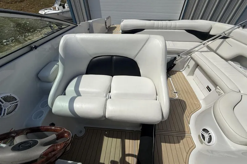 Slide: The Image of 2005 Crownline 288 BR boat interior with white leather seating and wood accents. - 21