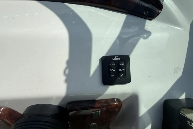 Slide: The Image of Control panel on 2005 Crownline 288 BR boat dashboard with Lenco trim tab switches. - 23