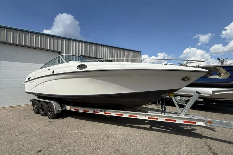 Slide: The Image of 2005 Crownline 288 BR boat on trailer, parked outdoors under blue sky. - 28